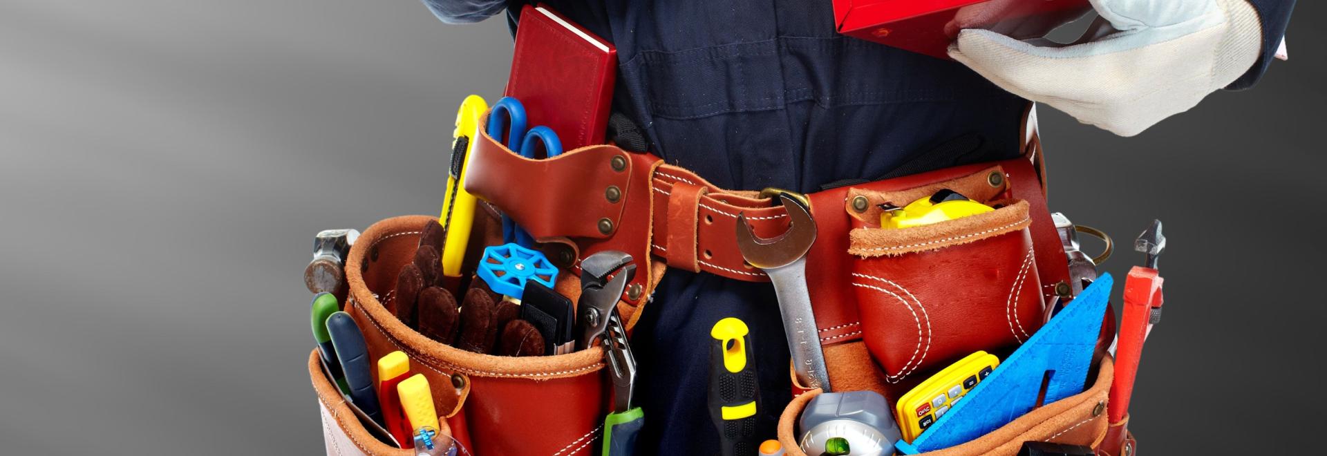 Plumbing and pipefitting professional standing with his tools.