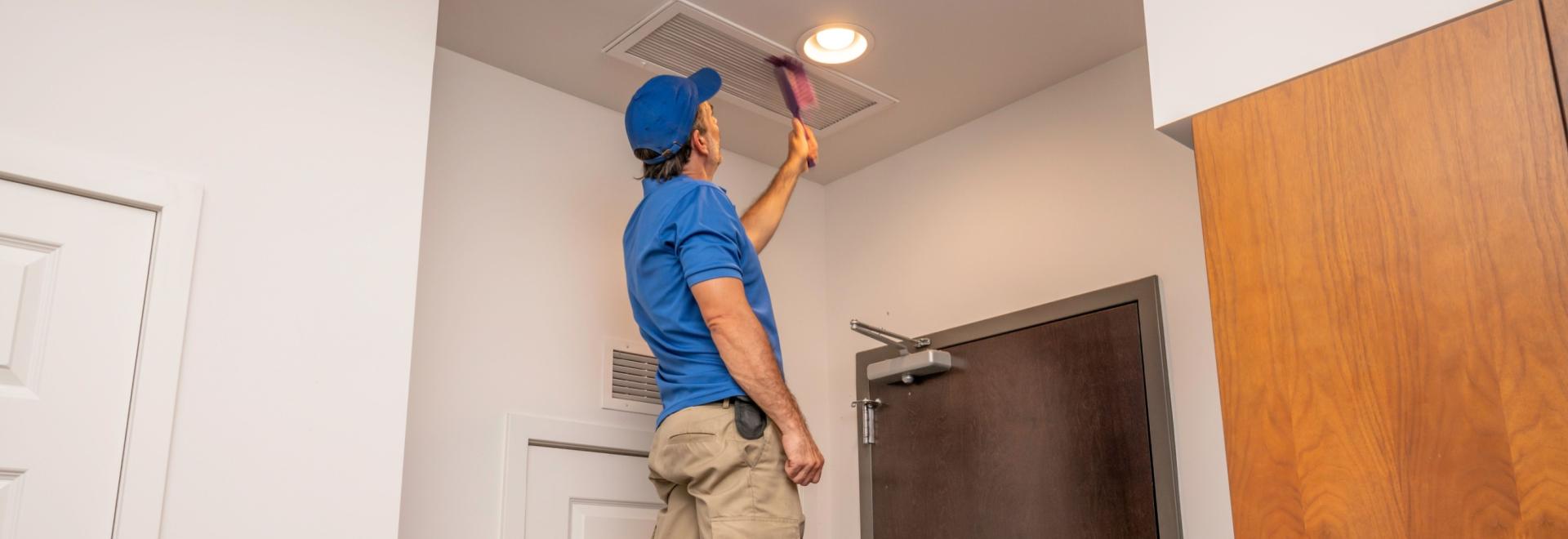 HVAC professional Cleaning an indoor air system.