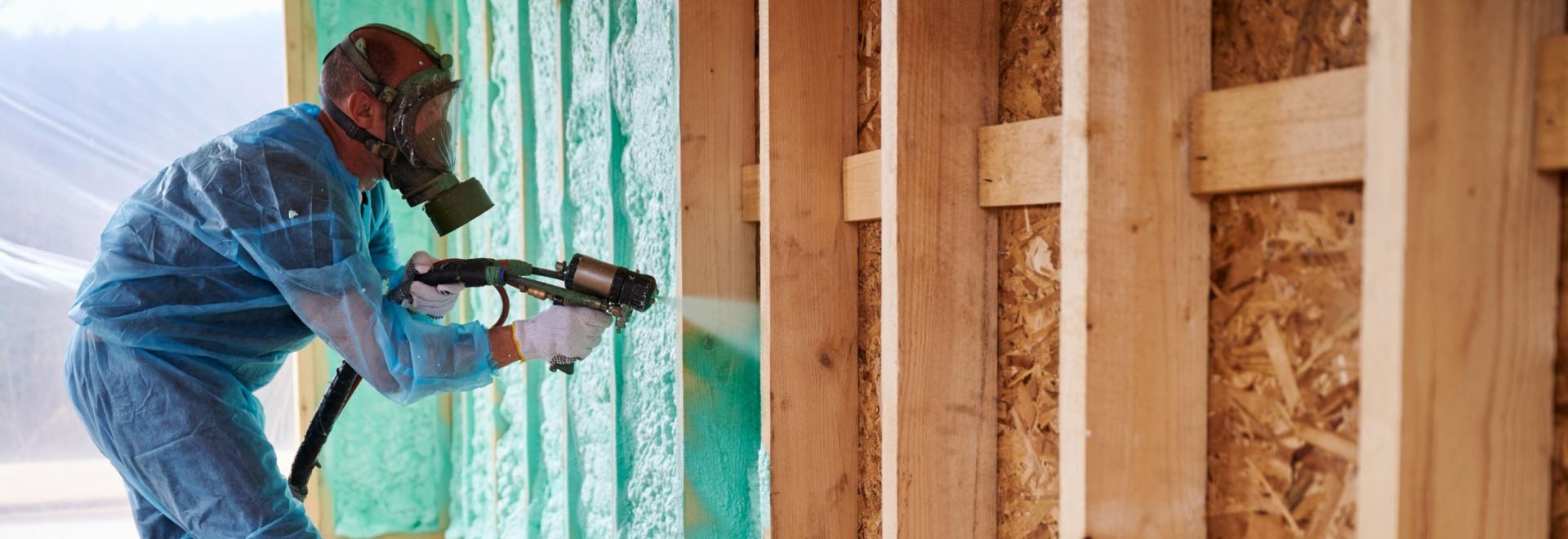 Home insulation in progress by a professional insulation worker.