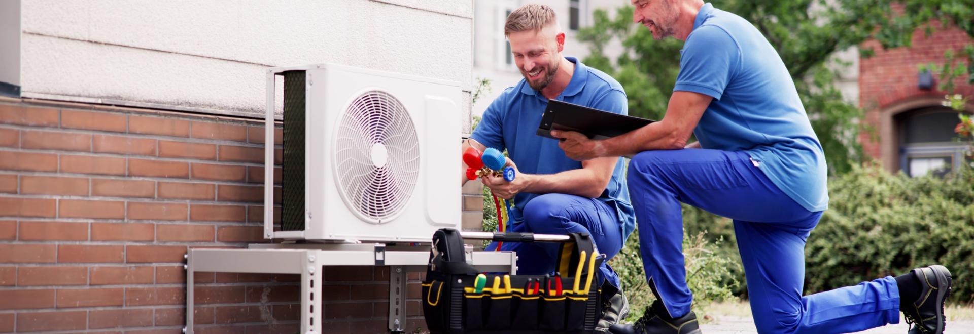 Two professionals repairing a heating system.