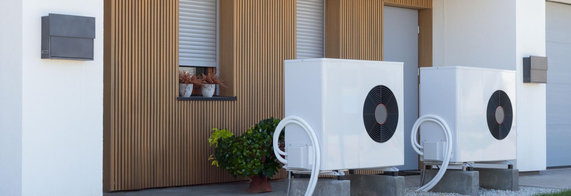 Two heat pumps outside a home.